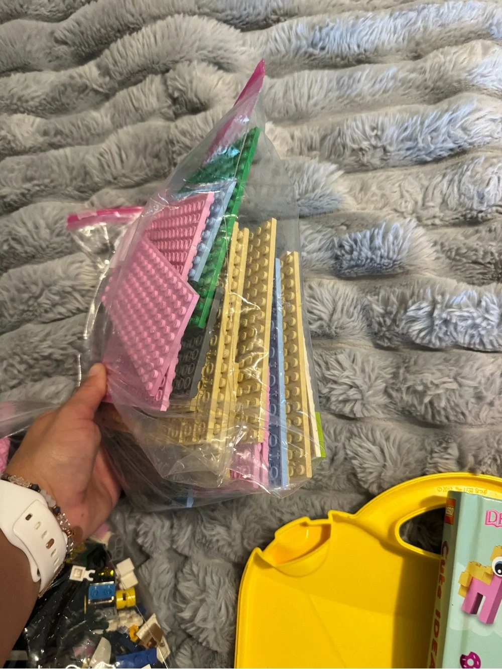 Lego Yellow and Orange Carry Cases filled with Lego bricks and a bag of boards